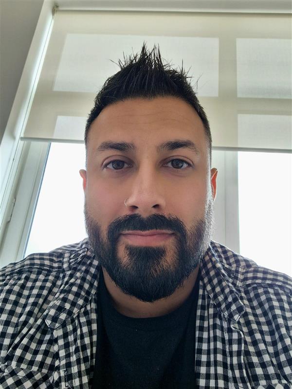 A headshot photo of Ash from our Product team.