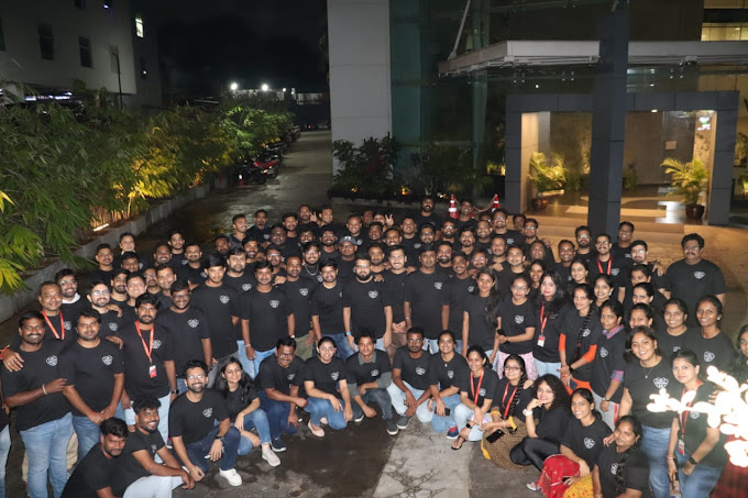 Our company team posing for a photo together just outisde of our building for one of our company celebrations