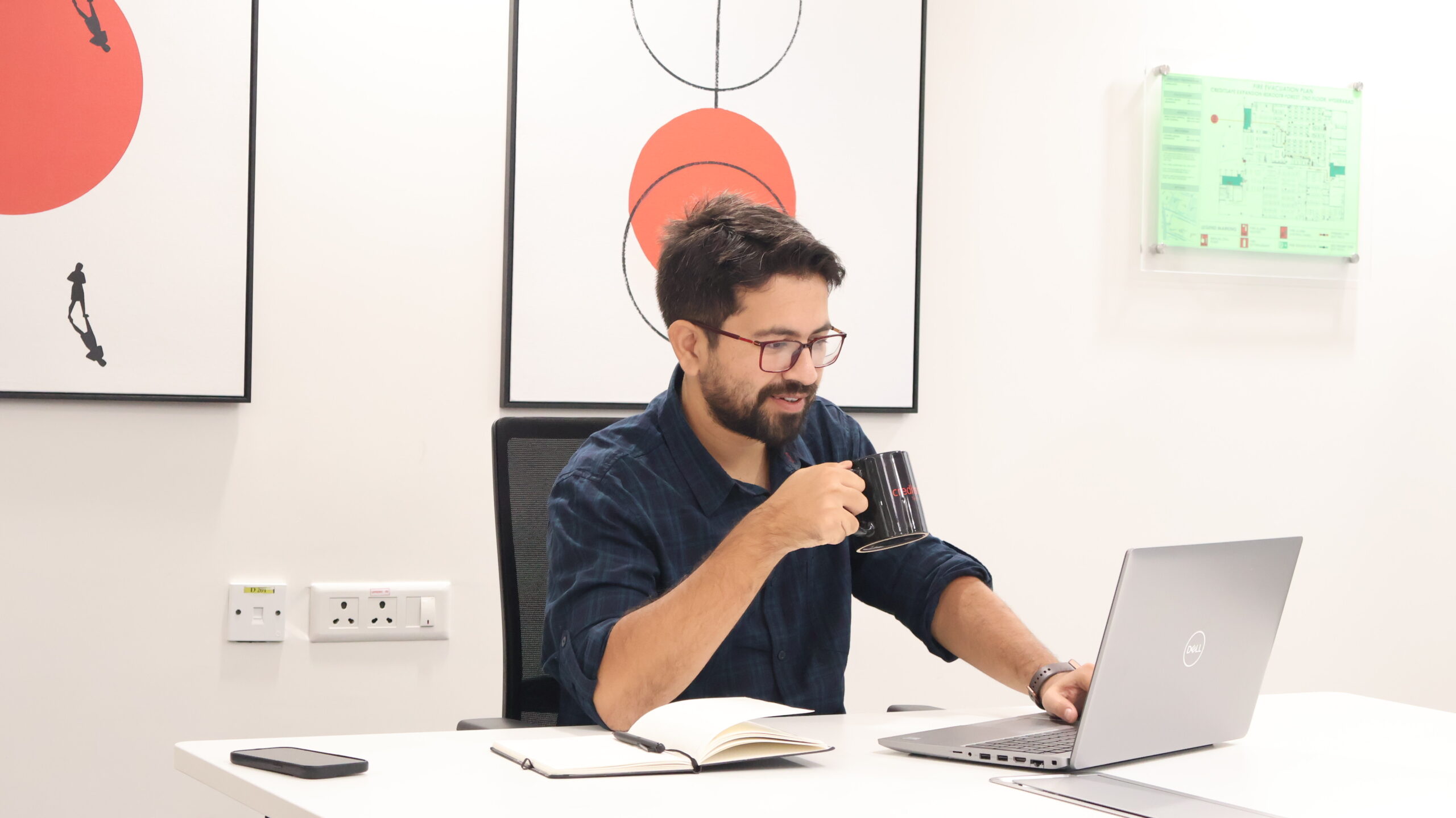 A member of our team enjoying a coffee while working