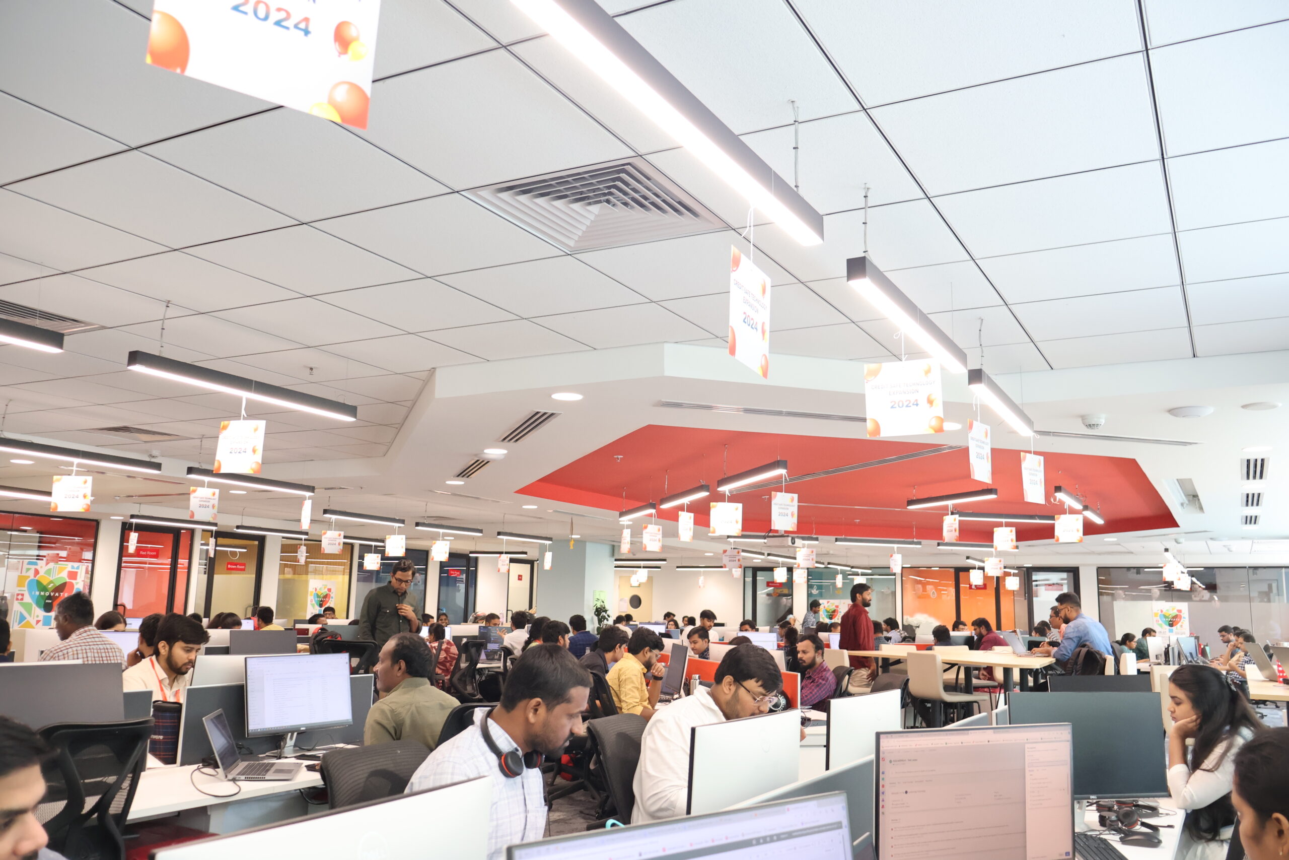 An open photo of our open office with members across our teams working