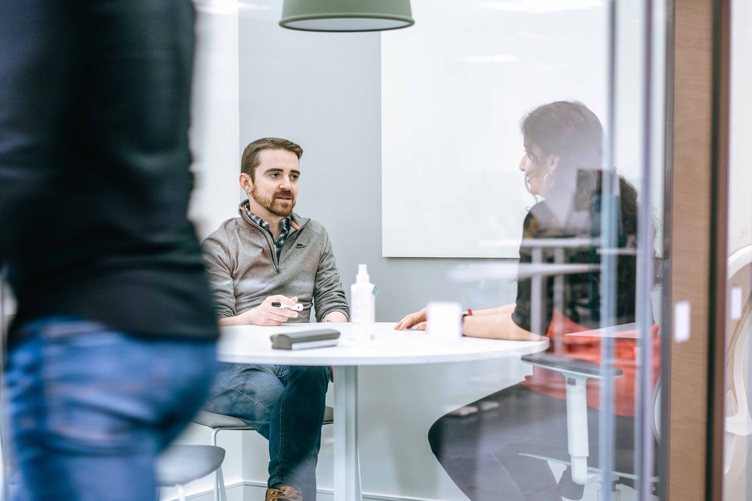 Two Creditsafe staff in a meeting room.